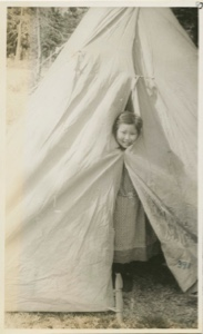 Image: Little Miriam Flowers putting head out of tent